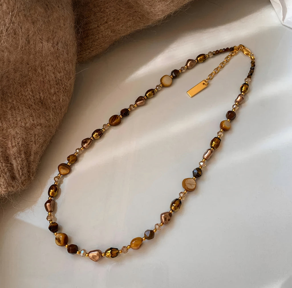 Waterproof stainless steel jewelry collection featuring hypoallergenic gold plated natural tiger eye pendant necklace and baroque pearl beaded necklace options