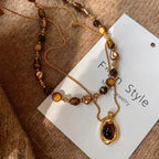Waterproof stainless steel jewelry collection featuring hypoallergenic gold plated natural tiger eye pendant necklace and baroque pearl beaded necklace options