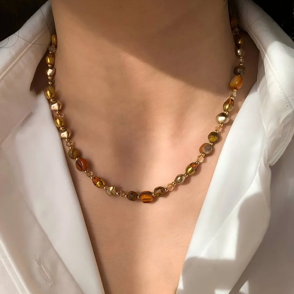 Waterproof stainless steel jewelry collection featuring hypoallergenic gold plated natural tiger eye pendant necklace and baroque pearl beaded necklace options