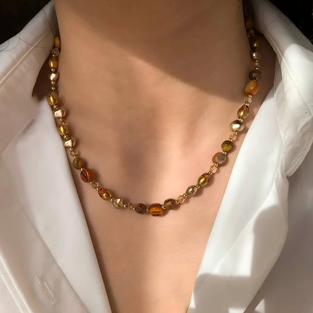 Waterproof stainless steel jewelry collection featuring hypoallergenic gold plated natural tiger eye pendant necklace and baroque pearl beaded necklace options