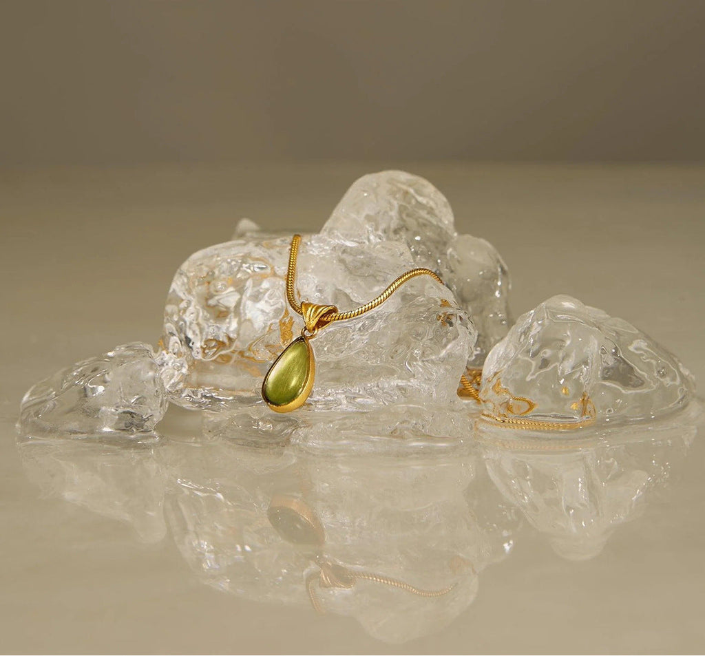 Waterproof stainless steel jewelry collection featuring hypoallergenic gold plated olive green glass teardrop pendant snake chain necklace.