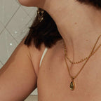Waterproof stainless steel jewelry collection featuring hypoallergenic gold plated olive green glass teardrop pendant snake chain necklace.