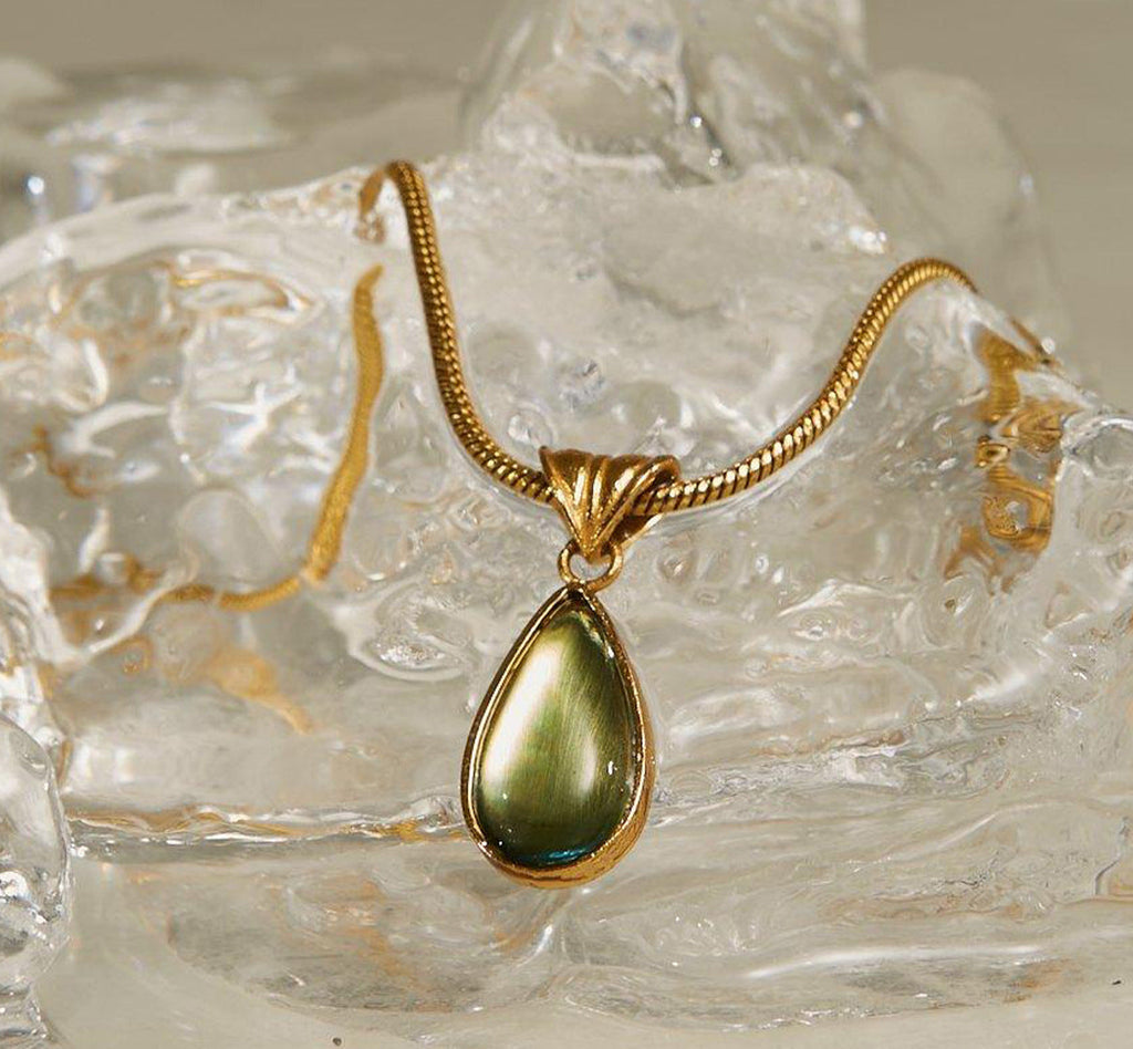 Waterproof stainless steel jewelry collection featuring hypoallergenic gold plated olive green glass teardrop pendant snake chain necklace.