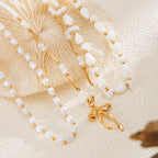 Waterproof stainless steel jewelry collection featuring hypoallergenic gold plated ribbon bow pendant pearl beaded 3-piece layered necklace set.