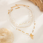 Waterproof stainless steel jewelry collection featuring hypoallergenic gold plated ribbon bow pendant pearl beaded 3-piece layered necklace set.