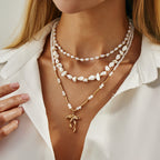 Waterproof stainless steel jewelry collection featuring hypoallergenic gold plated ribbon bow pendant pearl beaded 3-piece layered necklace set.