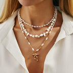 Waterproof stainless steel jewelry collection featuring hypoallergenic gold plated ribbon bow pendant pearl beaded 3-piece layered necklace set.