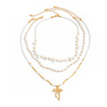 Waterproof stainless steel jewelry collection featuring hypoallergenic gold plated ribbon bow pendant pearl beaded 3-piece layered necklace set.