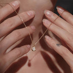 Waterproof stainless steel jewelry collection featuring 18k gold plated molten teardrop crystal pendant necklace.