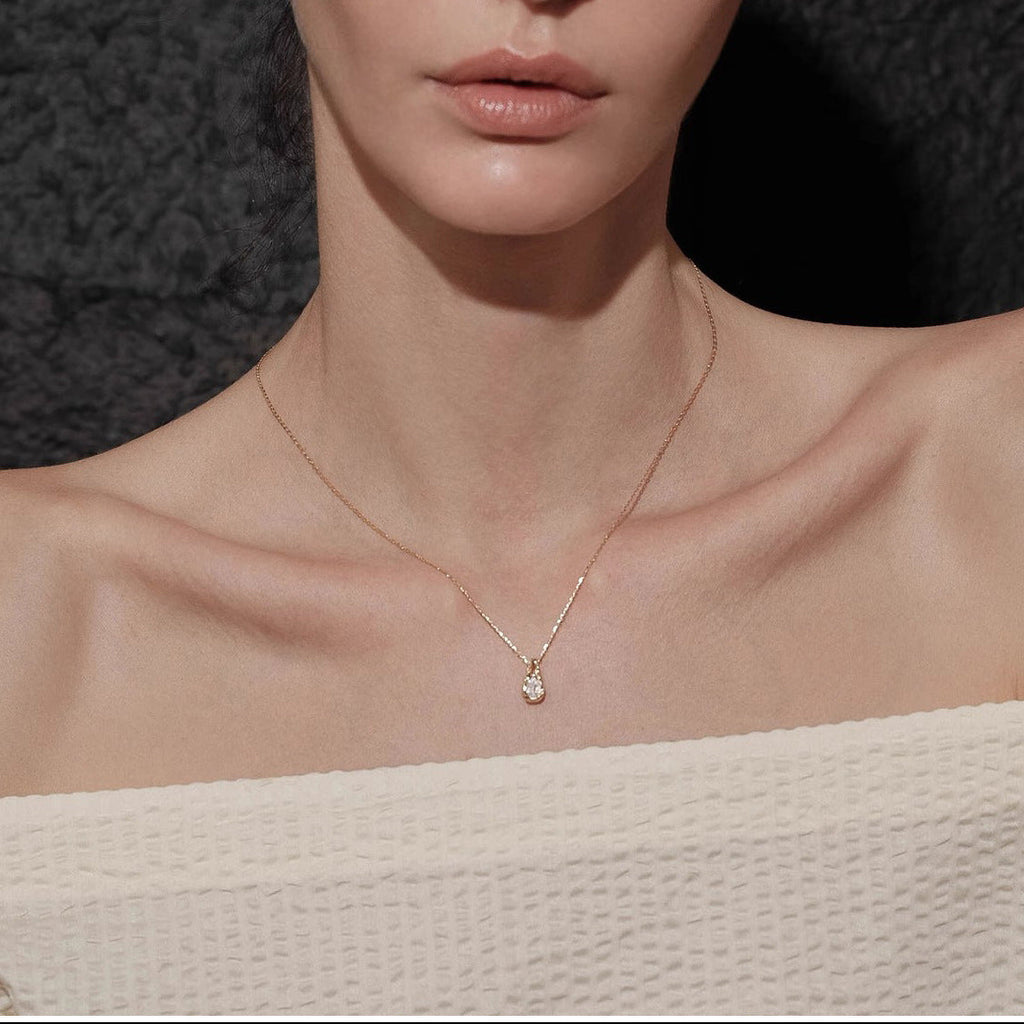 Waterproof stainless steel jewelry collection featuring 18k gold plated molten teardrop crystal pendant necklace.