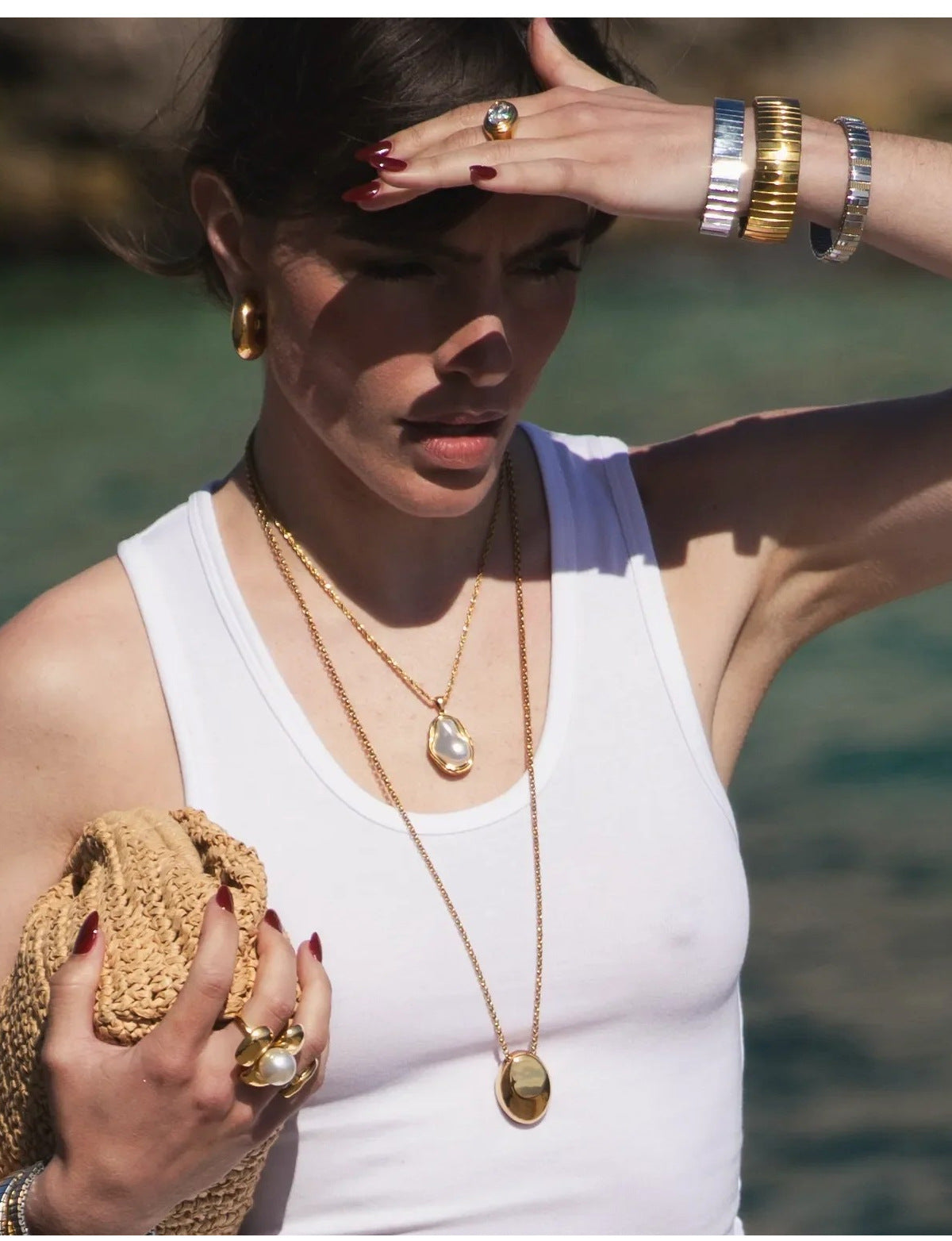 Waterproof stainless steel jewelry collection featuring hypoallergenic gold plated titanium steel smooth pebble pendant long necklace.