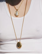 Waterproof stainless steel jewelry collection featuring hypoallergenic gold plated titanium steel smooth pebble pendant long necklace.