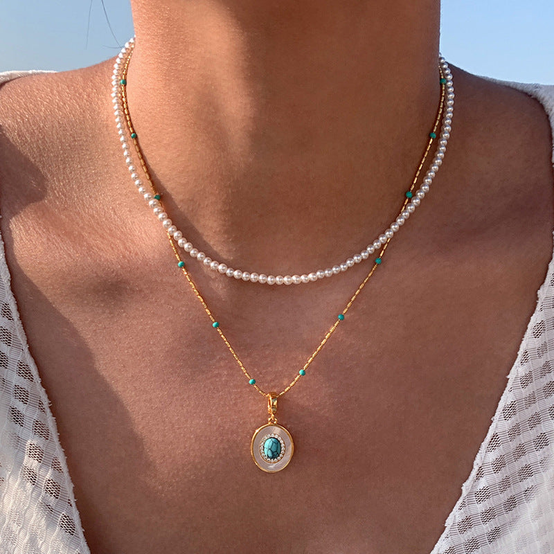 Waterproof stainless steel jewelry collection featuring hypoallergenic gold plated oval turquoise and mother of pearl pendant necklace.