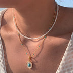 Waterproof stainless steel jewelry collection featuring hypoallergenic gold plated oval turquoise and mother of pearl pendant necklace.