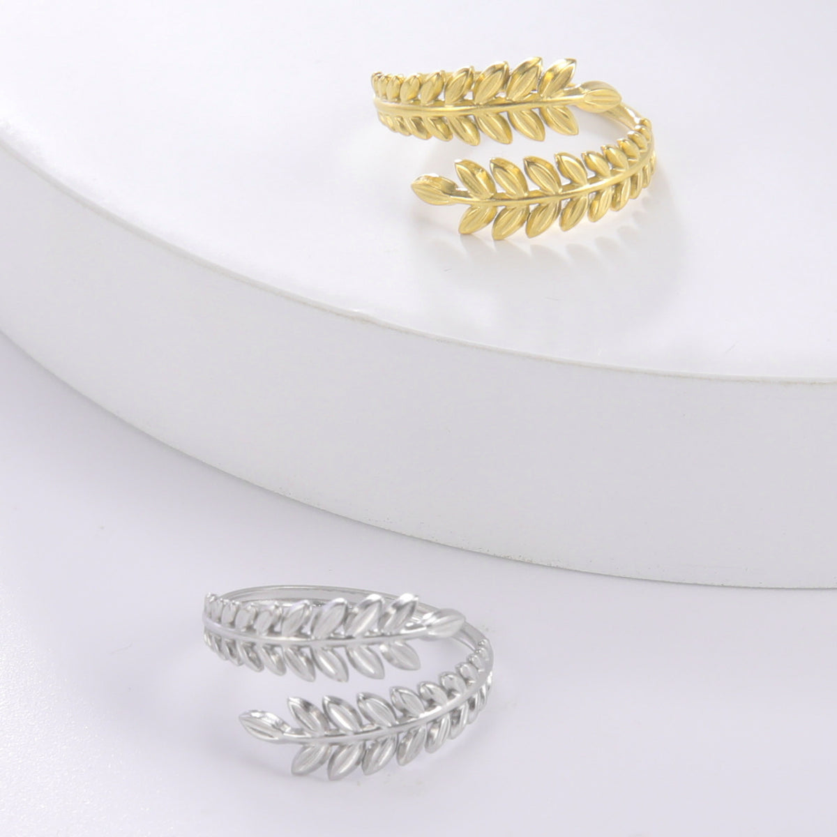 Textured wheat ear and olive laurel leaf motif wrap bypass open cuff adjustable ring stainless steel jewelry in waterproof 18k gold plated finish.