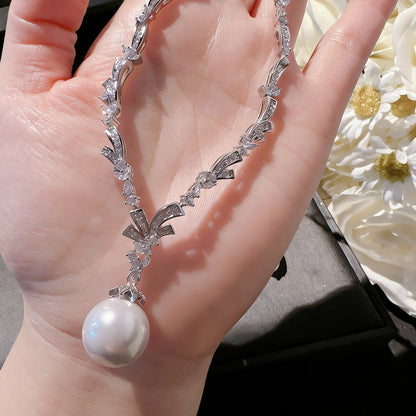 Elegant Y-shaped lariat necklace featuring a delicate pearl and sparkling cubic zirconia pendant