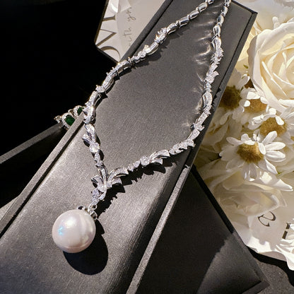 Elegant Y-shaped lariat necklace featuring a delicate pearl and sparkling cubic zirconia pendant